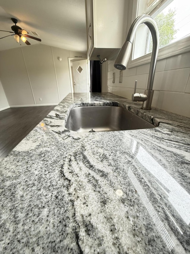 71 Pike St, Brodhead, KY 40409 - kitchen featuring a sink, tasteful backsplash, light stone countertops, ceiling fan, and wood finished floors