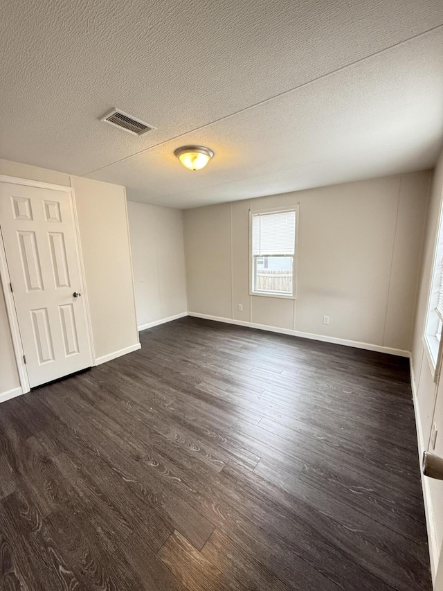 71 Pike St, Brodhead, KY 40409 - spare room with dark wood-style floors, a textured ceiling, and baseboards