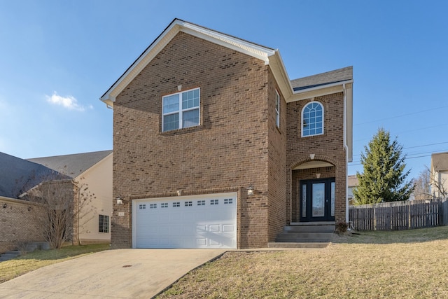 traditional home with brick siding, concrete driveway, an attached garage, and fence