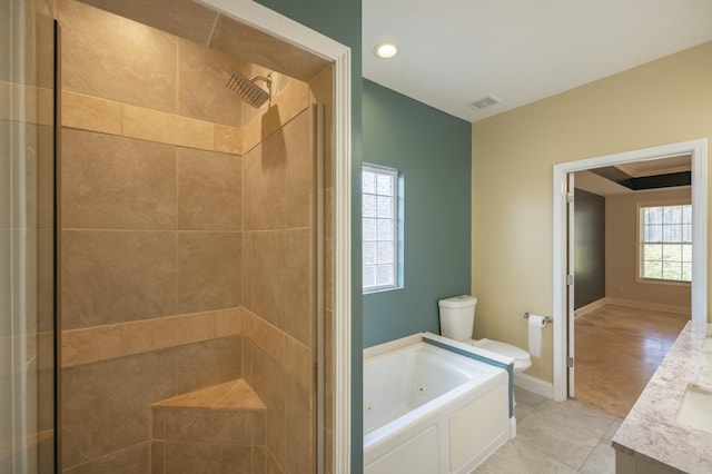 bathroom with visible vents, toilet, a stall shower, a tub with jets, and vanity