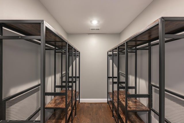 spacious closet featuring dark wood-style floors and visible vents