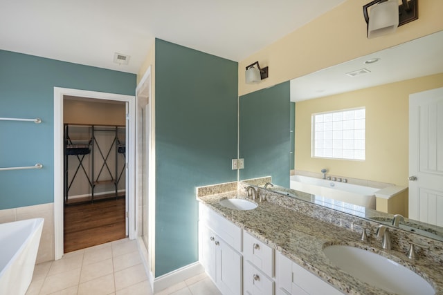 full bathroom with tile patterned floors, visible vents, and a sink