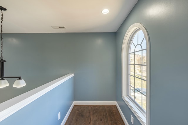 hallway with recessed lighting, dark wood-style floors, visible vents, and baseboards