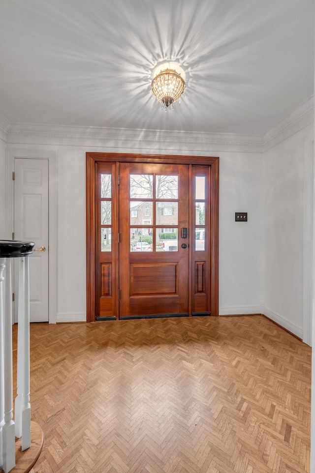 foyer featuring baseboards and ornamental molding