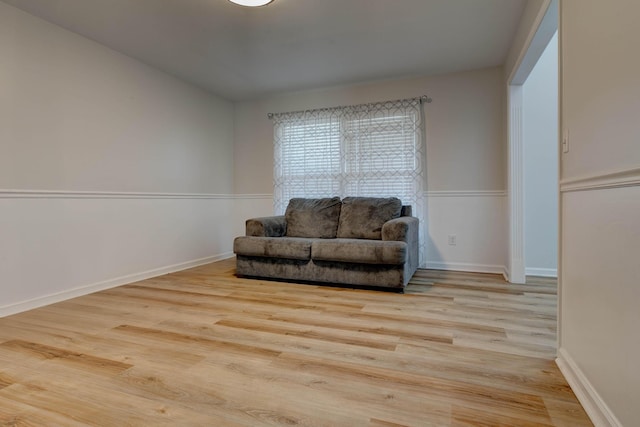 sitting room with light wood-type flooring and baseboards