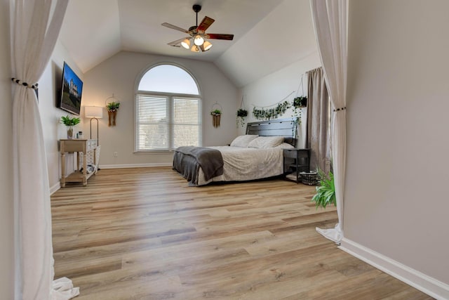 bedroom with lofted ceiling, ceiling fan, wood finished floors, and baseboards