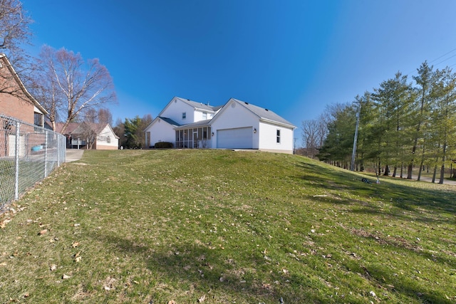 view of property exterior with fence, an attached garage, and a lawn