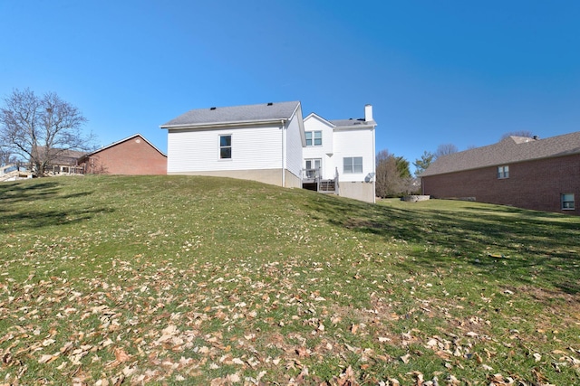 rear view of property with a lawn