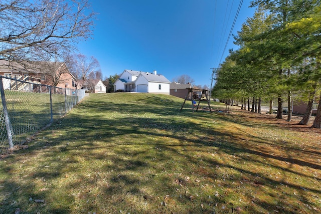 view of yard with fence and playground community