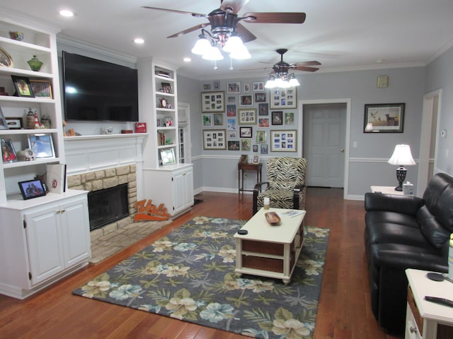 living area featuring a fireplace with flush hearth, crown molding, baseboards, and wood finished floors