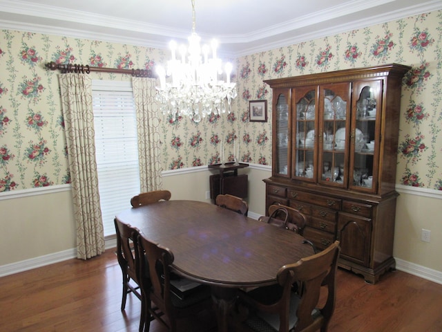 dining area featuring baseboards, a notable chandelier, wood finished floors, and wallpapered walls