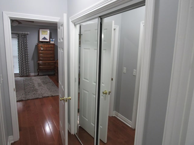 hall featuring baseboards and wood finished floors