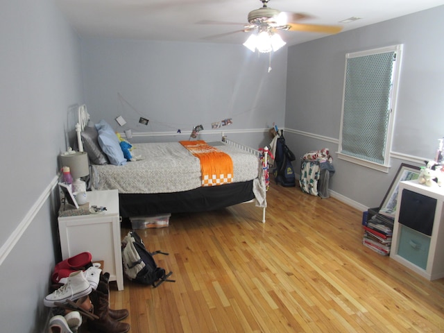 bedroom featuring hardwood / wood-style floors and ceiling fan