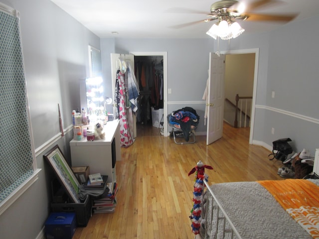 bedroom featuring a closet, light wood-style floors, and a ceiling fan