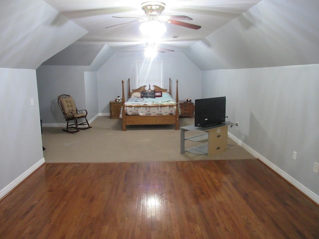 bedroom featuring baseboards, a ceiling fan, lofted ceiling, and wood finished floors