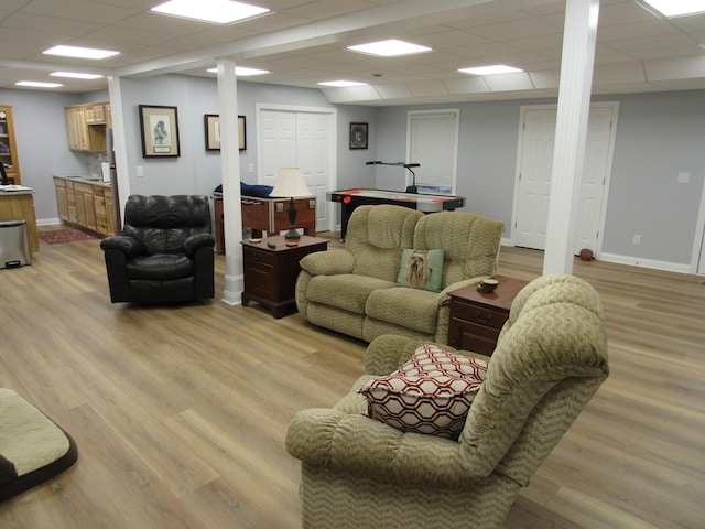 living room with baseboards and light wood-type flooring