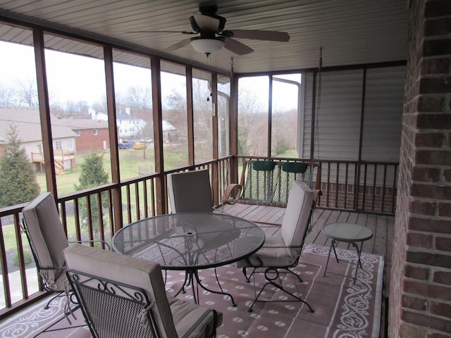 sunroom / solarium with a ceiling fan