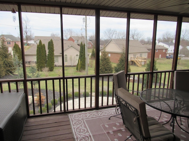 sunroom / solarium featuring a residential view