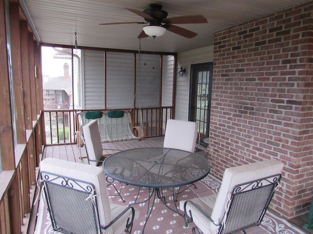 sunroom / solarium featuring ceiling fan