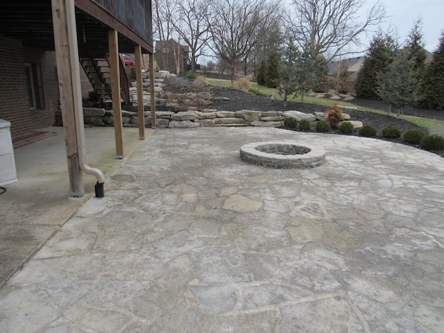 view of patio featuring stairway and an outdoor fire pit