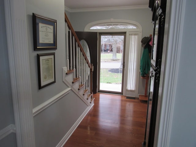 entryway featuring stairs, wood finished floors, visible vents, and ornamental molding