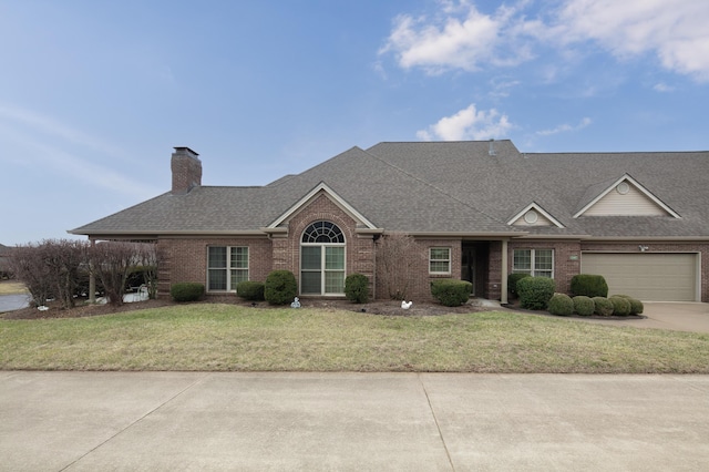 view of front of home with brick siding, roof with shingles, a chimney, concrete driveway, and a front yard