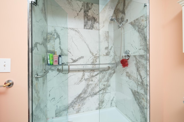 full bathroom with a marble finish shower