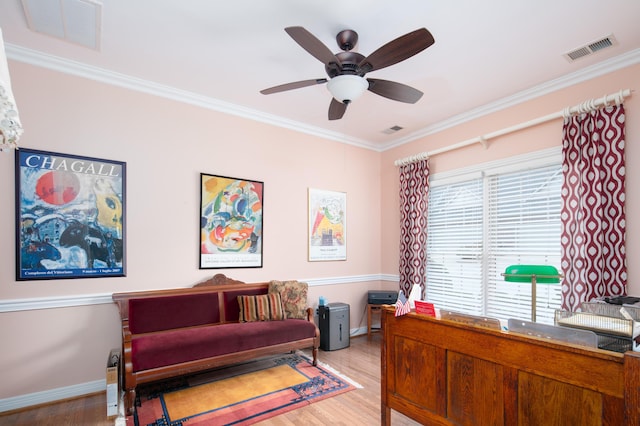 interior space with visible vents, crown molding, and wood finished floors