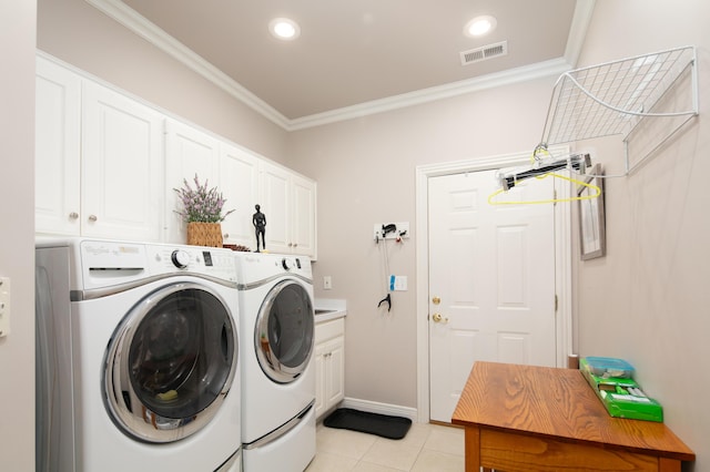 washroom with visible vents, washer and clothes dryer, and ornamental molding