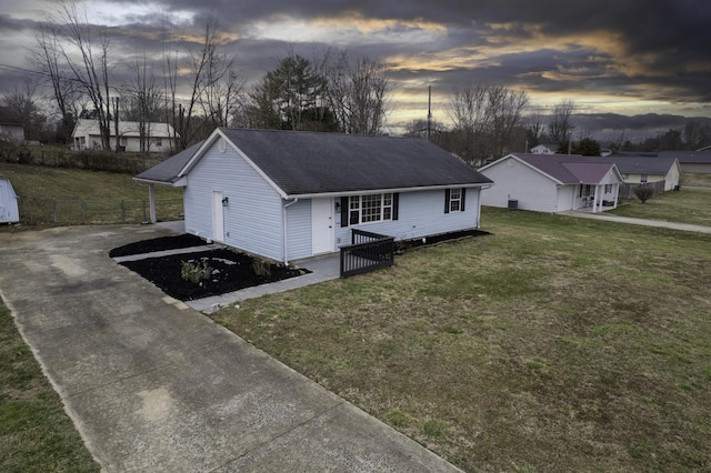 view of front of property with fence, a front lawn, and roof with shingles