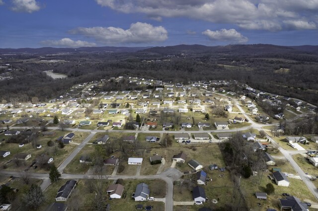 drone / aerial view featuring a residential view and a mountain view