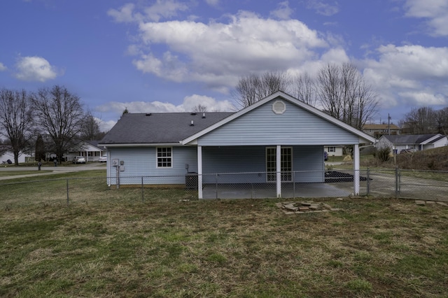 rear view of property featuring fence private yard, a gate, a patio, and a yard