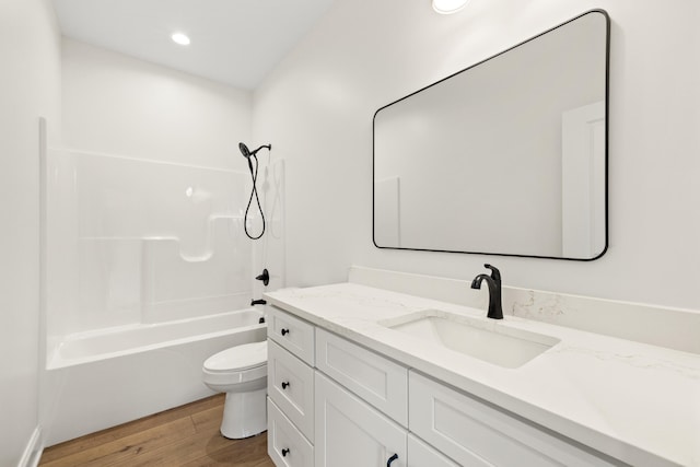 full bathroom with toilet, vanity, wood finished floors, shower / bathtub combination, and recessed lighting