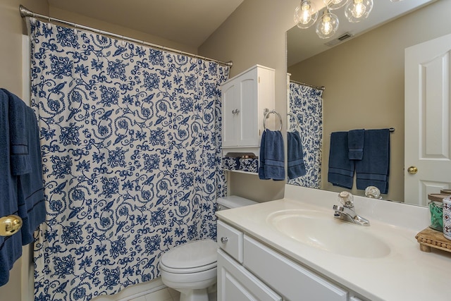 bathroom with visible vents, vanity, and toilet