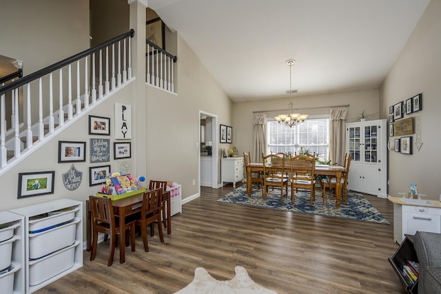 dining area with high vaulted ceiling, a notable chandelier, baseboards, stairs, and dark wood-style floors