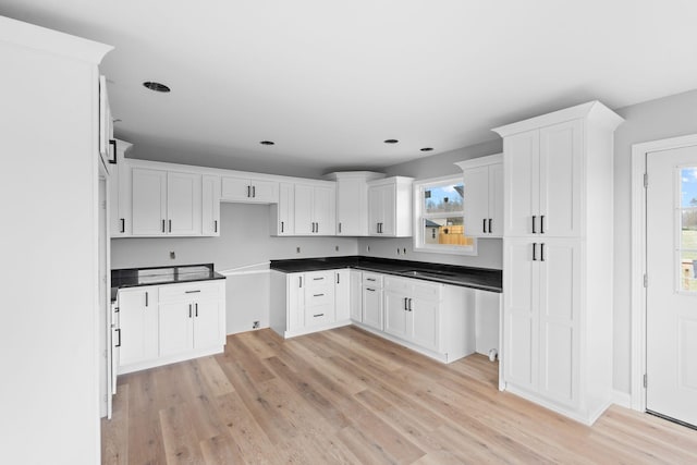 1000 Indian Trl, Lawrenceburg, KY 40342 - kitchen with dark countertops, light wood-style flooring, and white cabinets