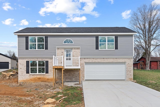 1000 Indian Trl, Lawrenceburg, KY 40342 - split foyer home featuring a front lawn, an attached garage, brick siding, and driveway