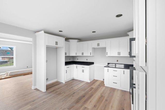 1000 Indian Trl, Lawrenceburg, KY 40342 - kitchen with dark countertops, white cabinets, baseboards, and light wood-style floors