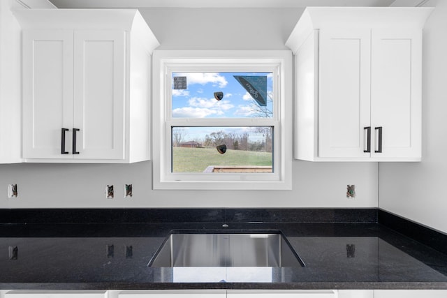 1000 Indian Trl, Lawrenceburg, KY 40342 - kitchen with white cabinetry, dark stone counters, and a sink