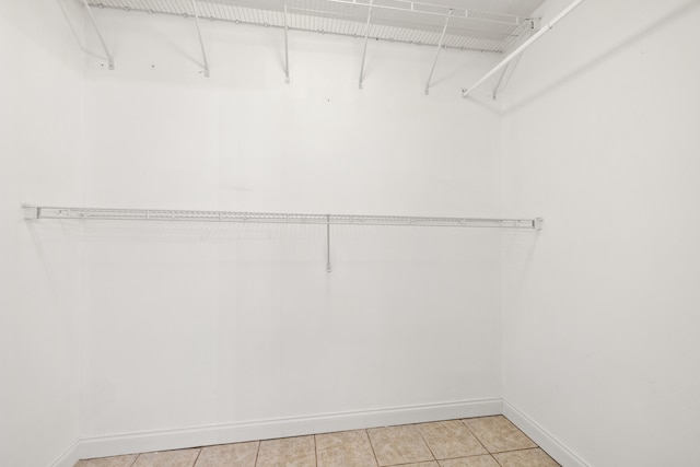 spacious closet featuring light tile patterned floors