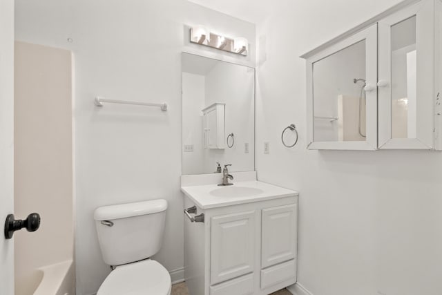 bathroom featuring vanity, toilet, and baseboards