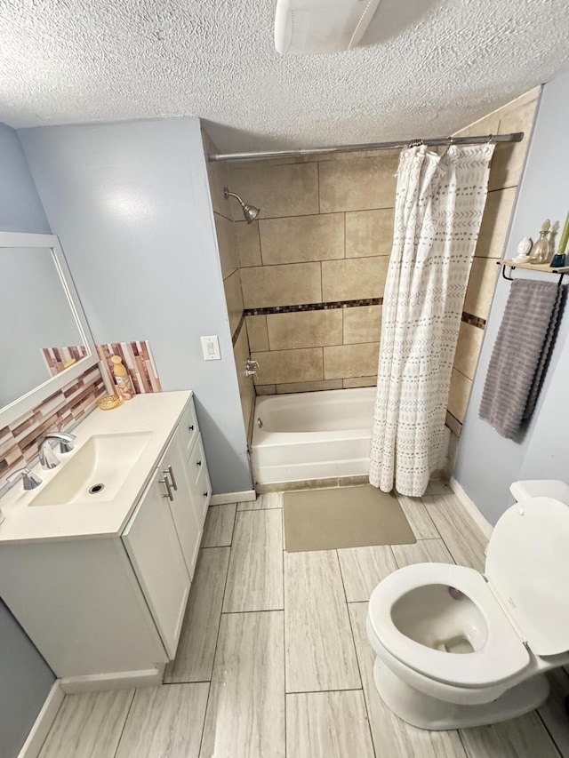 full bath featuring a textured ceiling, toilet, vanity, wood tiled floor, and shower / bath combo with shower curtain