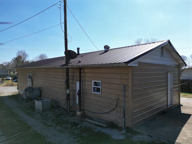 back of property featuring metal roof