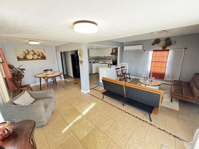 living room with washing machine and dryer, baseboards, and an AC wall unit