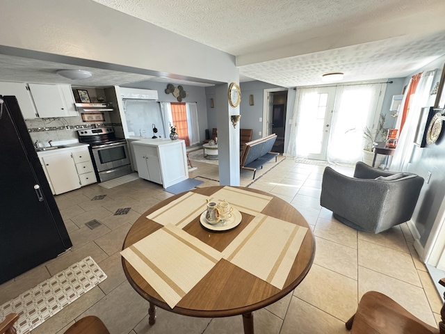 living room featuring a textured ceiling, french doors, and light tile patterned floors