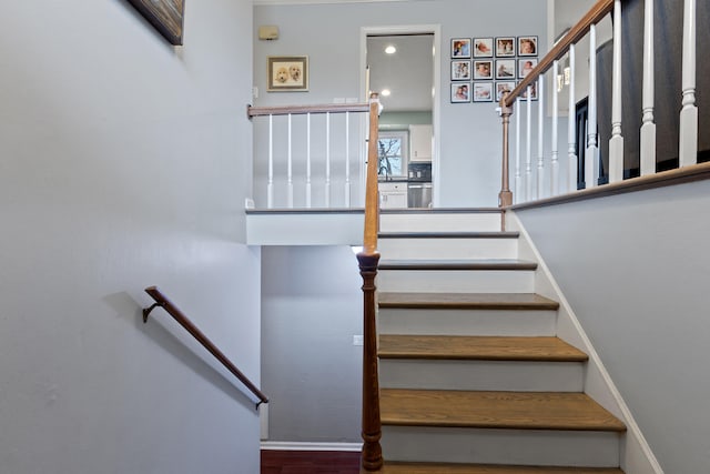 staircase featuring baseboards