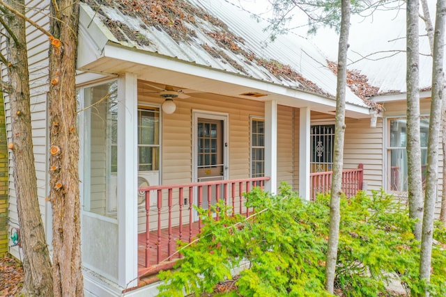 view of exterior entry featuring metal roof, covered porch, and a ceiling fan