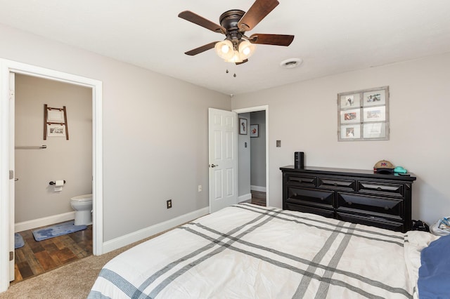 bedroom featuring visible vents, baseboards, ensuite bath, ceiling fan, and carpet flooring