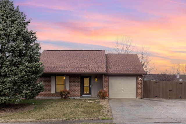 view of front of home with roof with shingles, brick siding, fence, a garage, and driveway