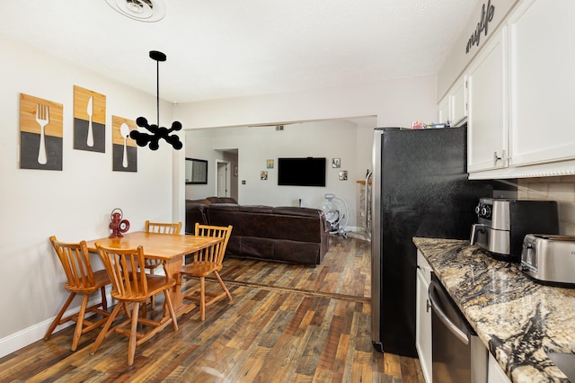 dining area with dark wood-type flooring, visible vents, and baseboards